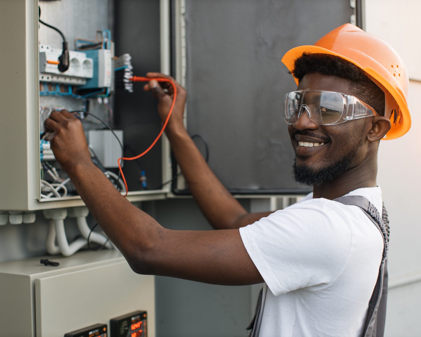 Electrician checking cables in an electrical panel