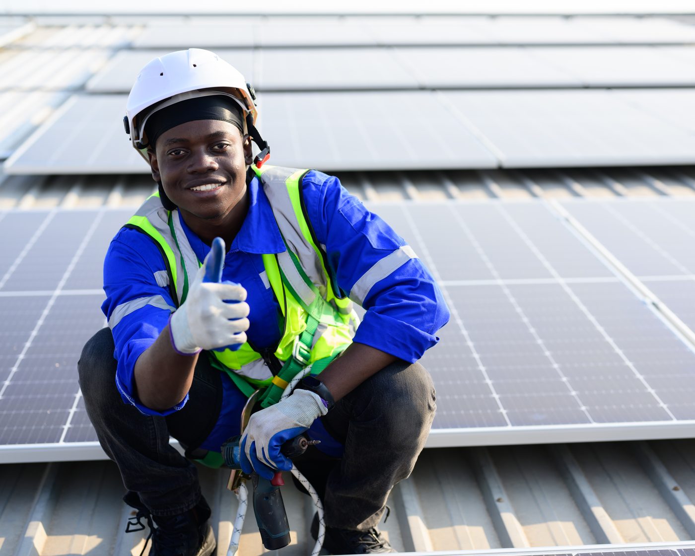 Worker installing solar panels on a rooftop