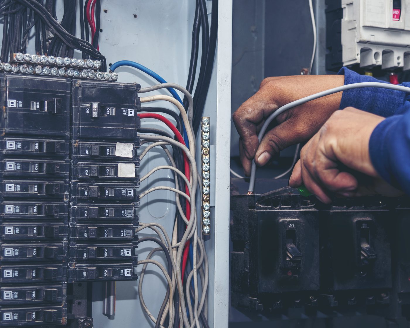 Close-up of a LetroSpark electrician wiring a junction box