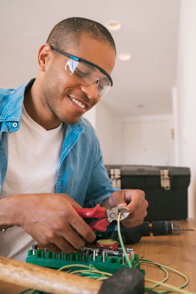 Adult man doing electrical work inside homeutc