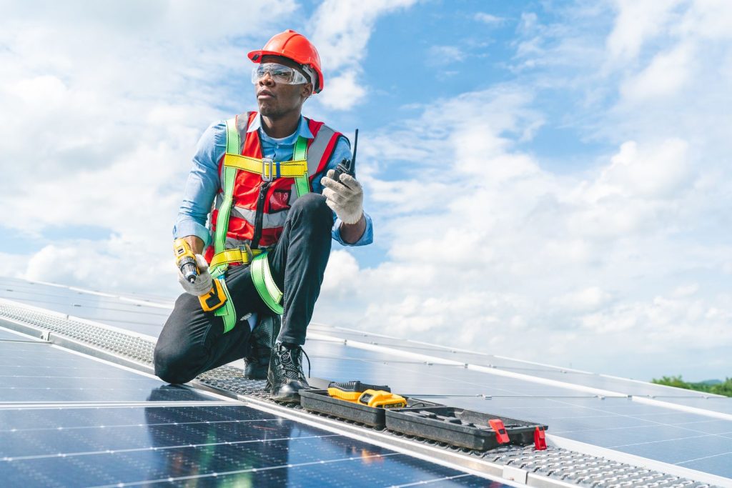 African american engineer maintaining solar cell putc