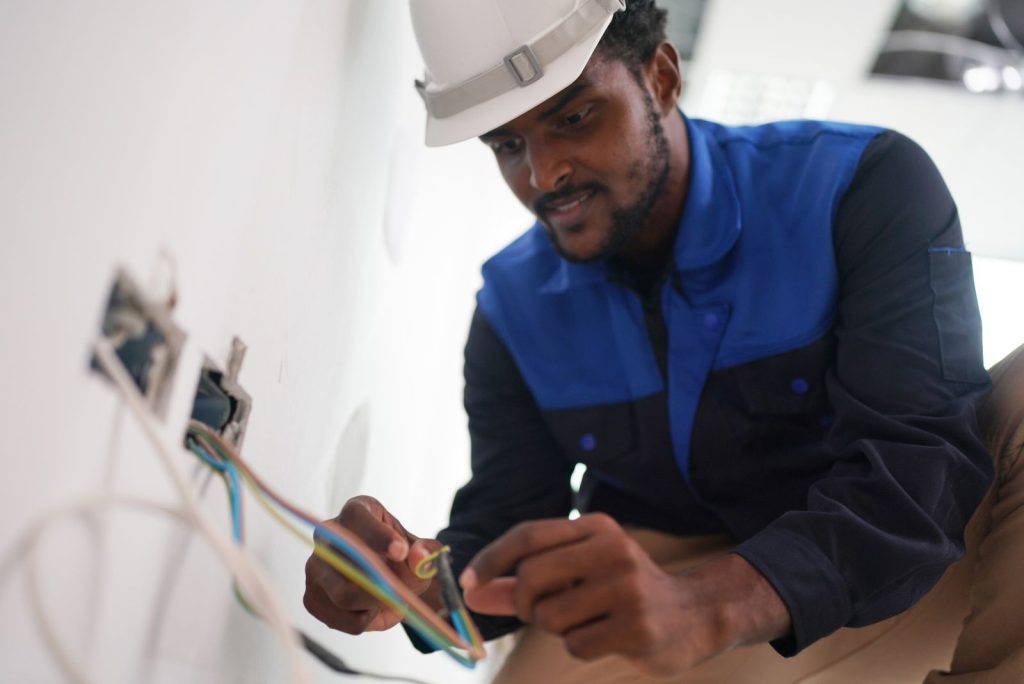 Electrician working on wiring in a buildingutc
