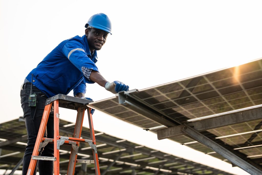Man installs solar panel on sunny dayutc