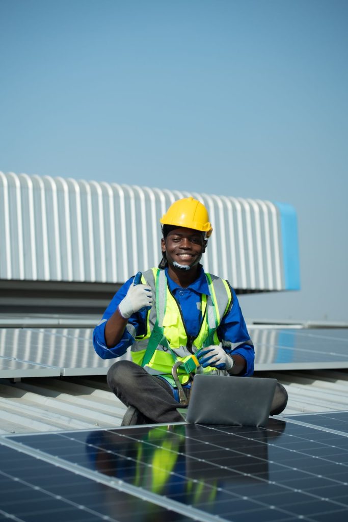 Solar panel technician inspecting panels on roofutc