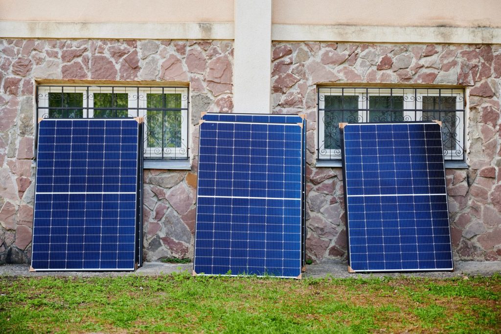 Solar panels awaiting installation against stone wutc