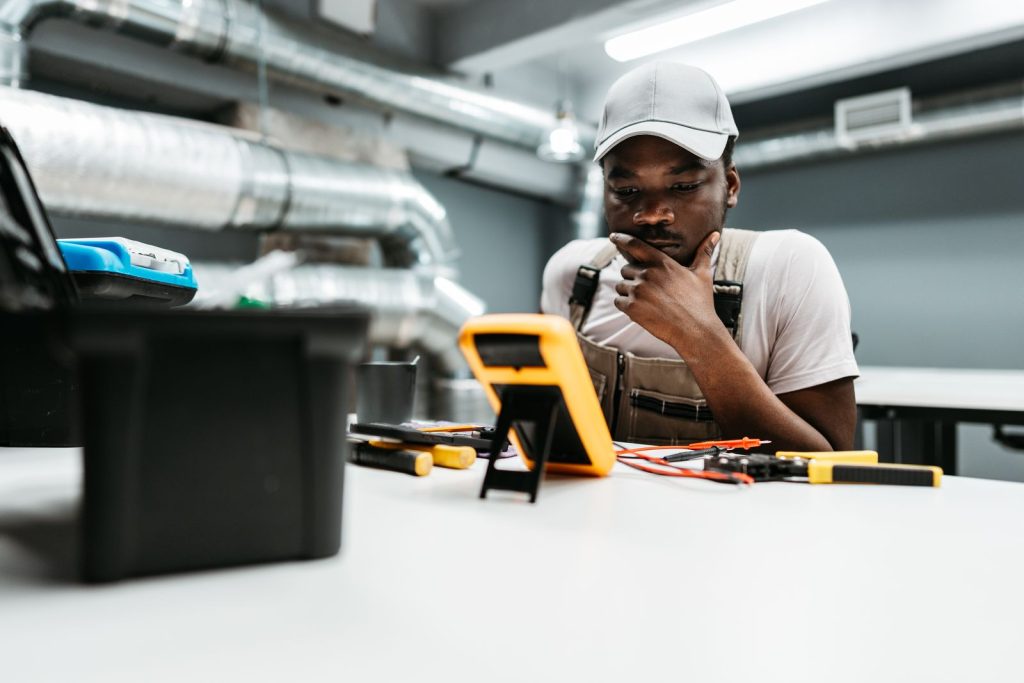 Young technician analyzes readings on a multimeterutc