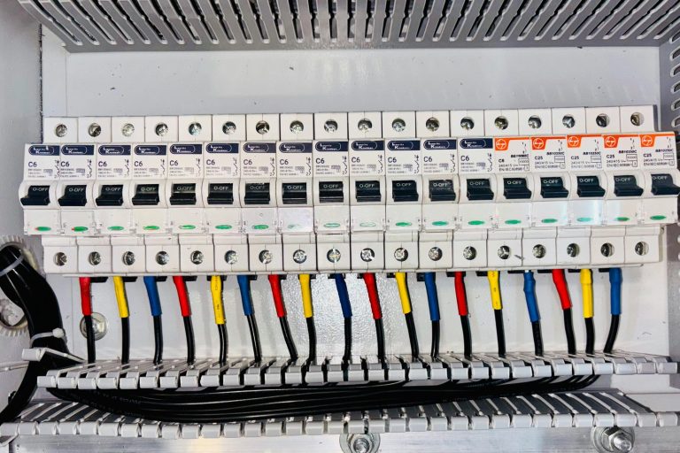 Close-up of an organized circuit breaker panel featuring color-coded electrical wiring.