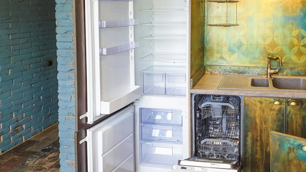 Stylish kitchen interior featuring an open refrigerator and dishwasher, showcasing contemporary design.