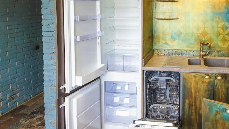 Stylish kitchen interior featuring an open refrigerator and dishwasher, showcasing contemporary design.