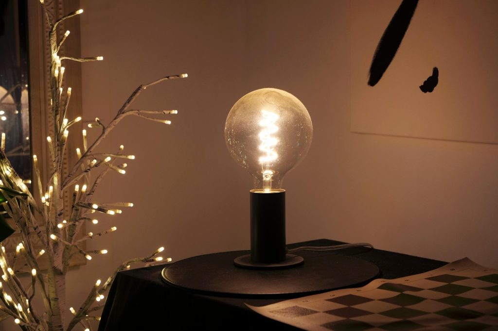Warm lighting from LED bulb on table, creating a cozy indoor ambiance.