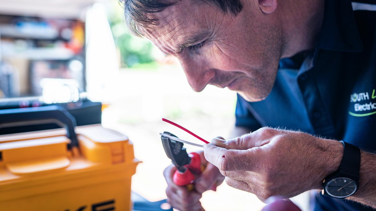 An electrician working on a wire