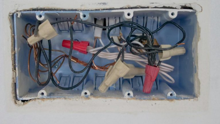 Detailed view of an opened electrical switchboard with visible wires and connectors.