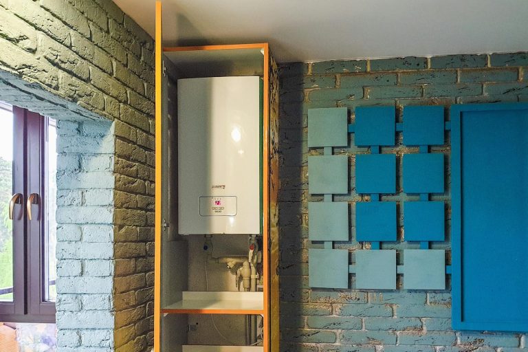 Indoor view of a water heater neatly installed in a cabinet with modern decor.