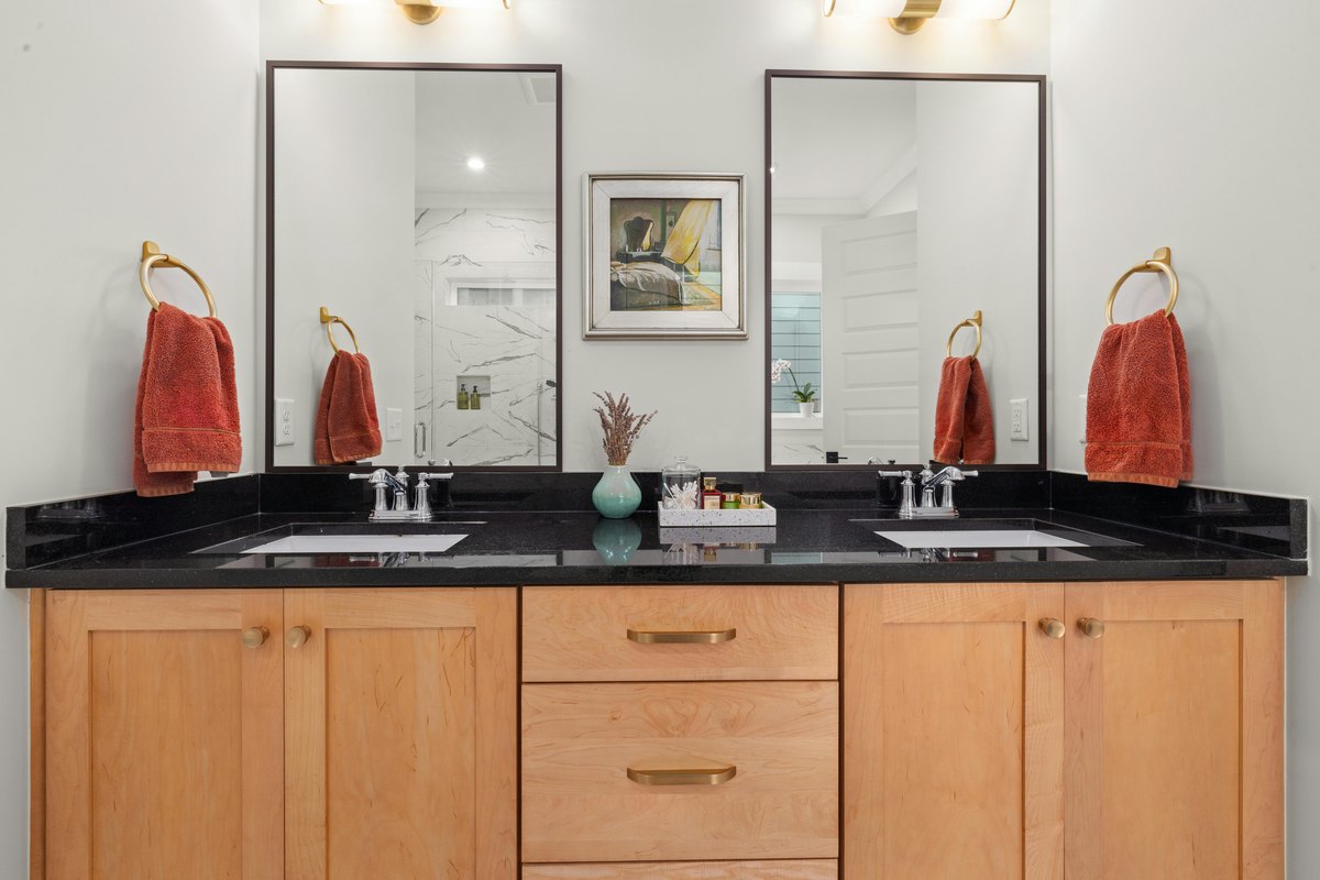 A bathroom vanity with mirror and lighting