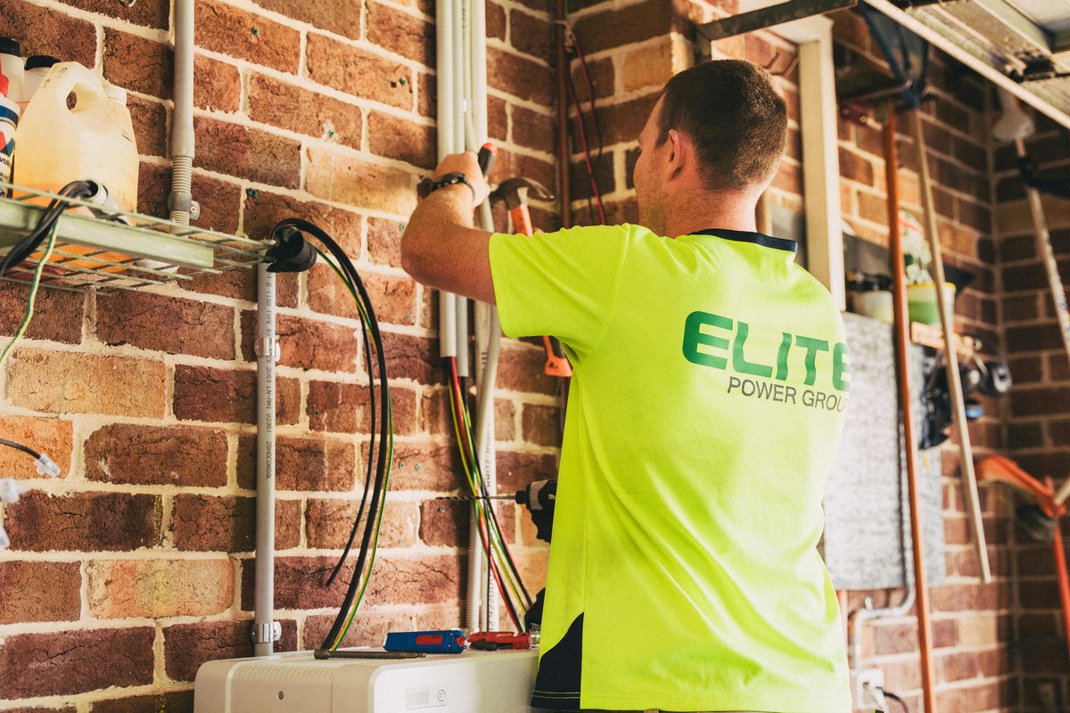 An electrician working on a solar battery installation