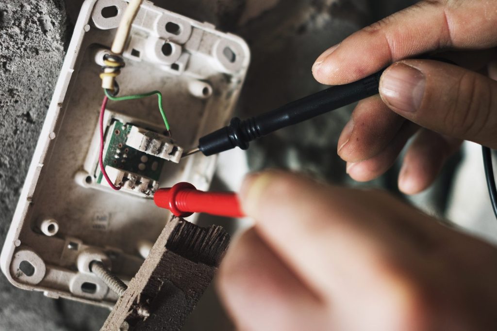 Electrician diagnosing a voltage fault